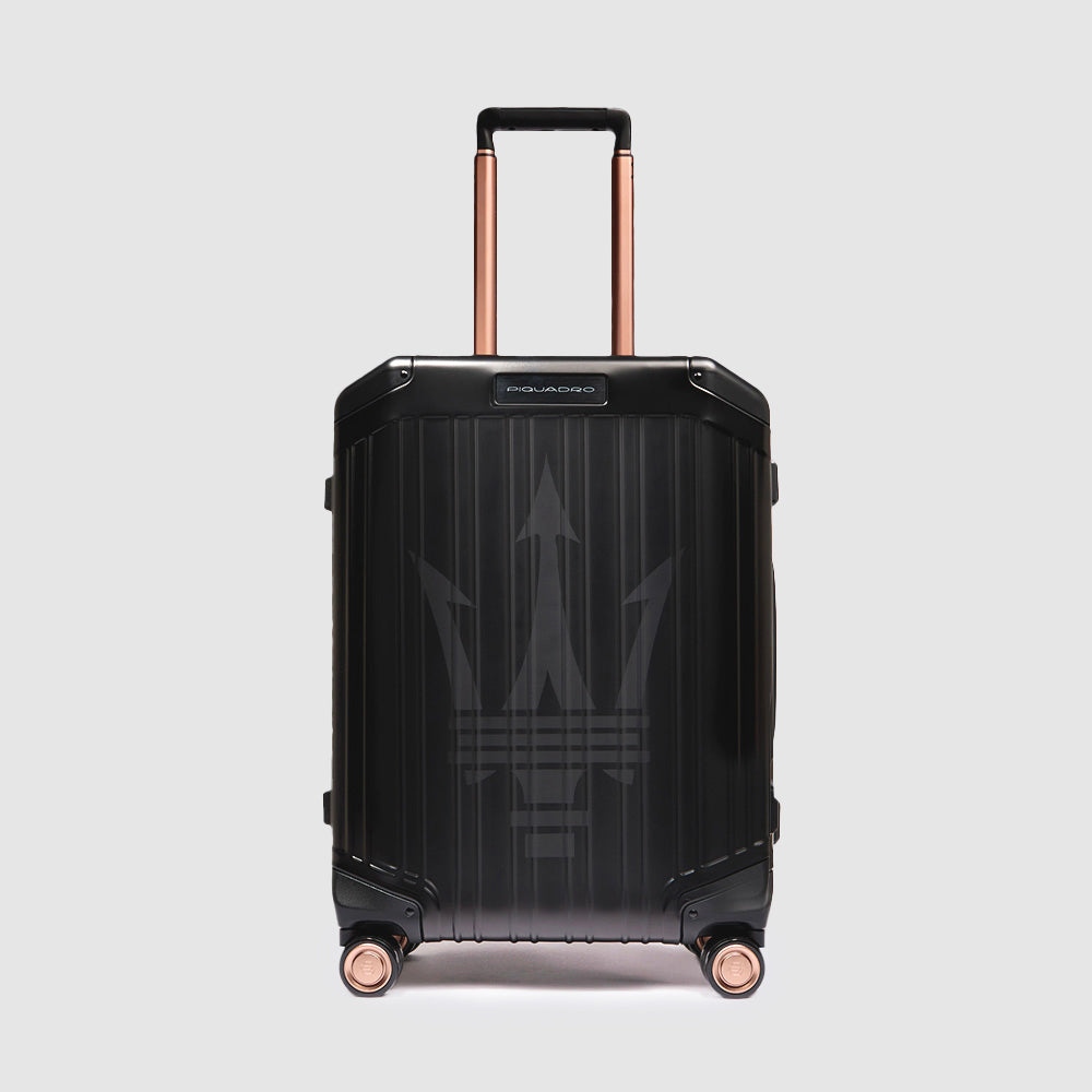 Black aluminium Piquadro × Maserati cabin spinner with rose-gold accents, stamped logo, TSA lock, telescopic handles, 31 L capacity.